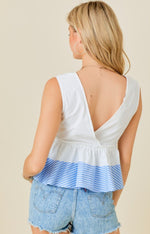 White v-neck top with blue ruffle